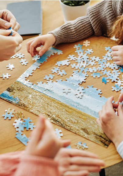 Hands working on a jigsaw puzzle